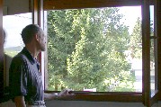 Tom (Paul) views neighborhood from hostel room