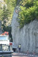 Highway workers erect falling rock protection