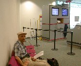 Tom (Paul) occupies himself during airport wait