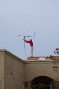 Paul balances on the roof adjusting antenna Paul balances on the roof adjusting antenna