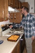 Paul readies the oven for one of our last main meals of the year 2003 Paul readies the oven for one of our last main meals of the year 2003