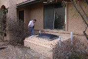 Paul works on uprights for first window well cover