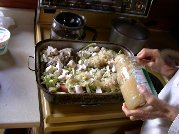 Kitty puts finishing touches on browned roast before putting into oven