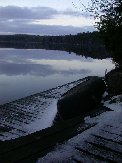 The sun below the horizon still provides enough light on the well-used canoe &lsquo;abandoned&rsquo; for the season