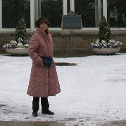 Decorative cabbage and evergreens behind Kitty at Allan Gardens Decorative cabbage and evergreens behind Kitty at Allan Gardens