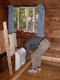 Paul disassembling old bedframe in what will eventually be his and Kitty&rsquo;s bedroom