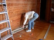 Paul takes the baseboard heater off the wall that will eventually be removed