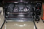 Toaster overn used to bake individual sweet potato servings wrapped in aluminum foil Toaster overn used to bake individual sweet potato servings wrapped in aluminum foil
