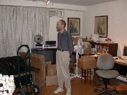 Paul contemplates the remaining shelves and books along wall of living room