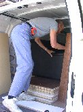 Paul looks over the sofa and desk placement in the van