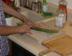 Carefully slitting open the side of well scrubbed leaf Carefully slitting open the side of well scrubbed leaf
