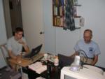 Olafur uses the laptop on makeshift desk in Paul's and Kitty's office