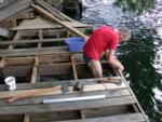 Removing some fastener hardware on outer dock beam after pulling up old post