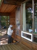 The original lower window frame is removed in preparation for sliding out shorter logs