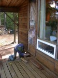 Final preparation before removing shorter logs each of which is toe-nailed into end piece