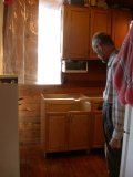 Paul in the process of putting the kitchen lower cabinet back together