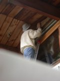 Plain plywood under eave is now covered with cedar logs like rest of cottage