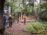 Bill trims stump and helpers gather up equipment